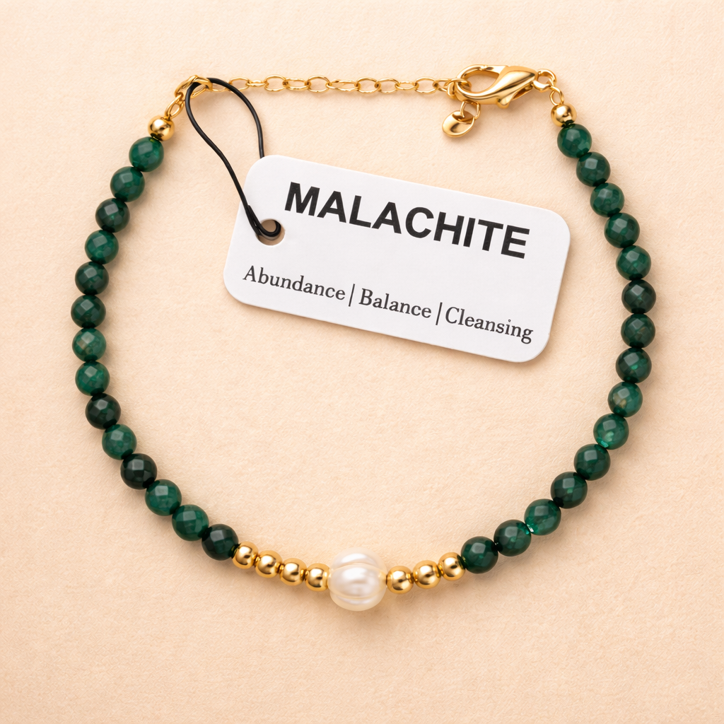 Faceted malachite bead with 'The Blue Yogi' tag on a beige background