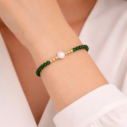 green beaded bracelet on a wrist with a natural background